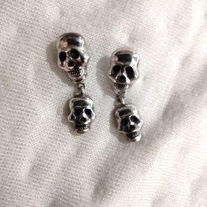 Sterling silver, skull, pierced earrings. 1 inch.